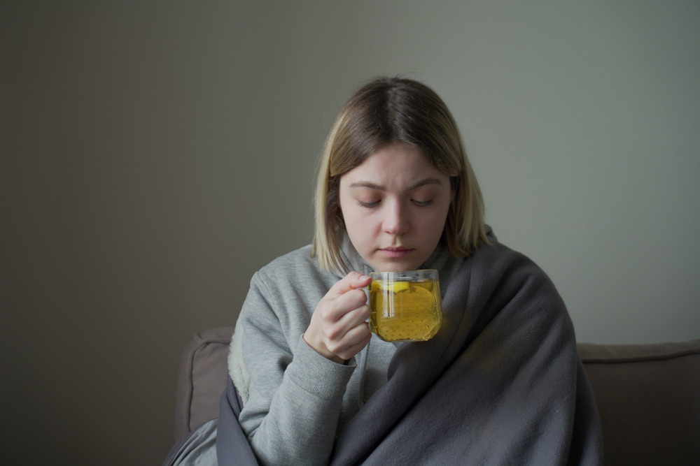 A woman drinking herbal tea for sleep