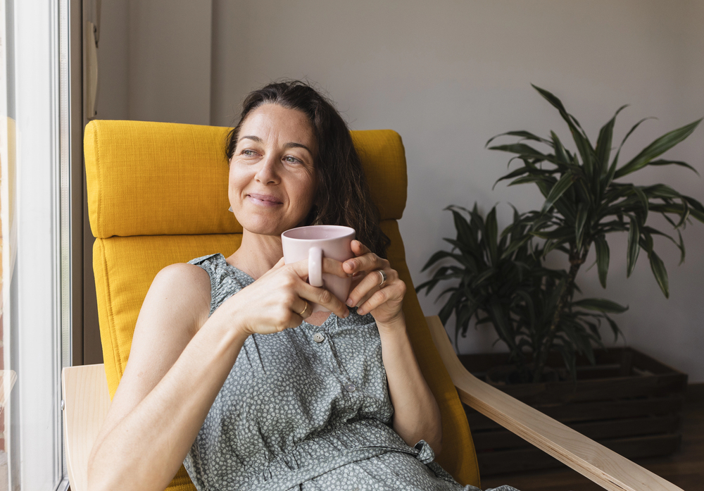 Woman enjoying the best herbal teas for relaxation.