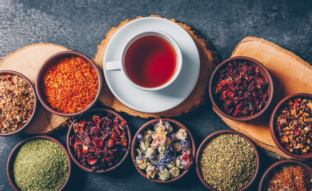 A Set of wood stubs and a cup of tea and tea herbs in  bowl as great herbal tea